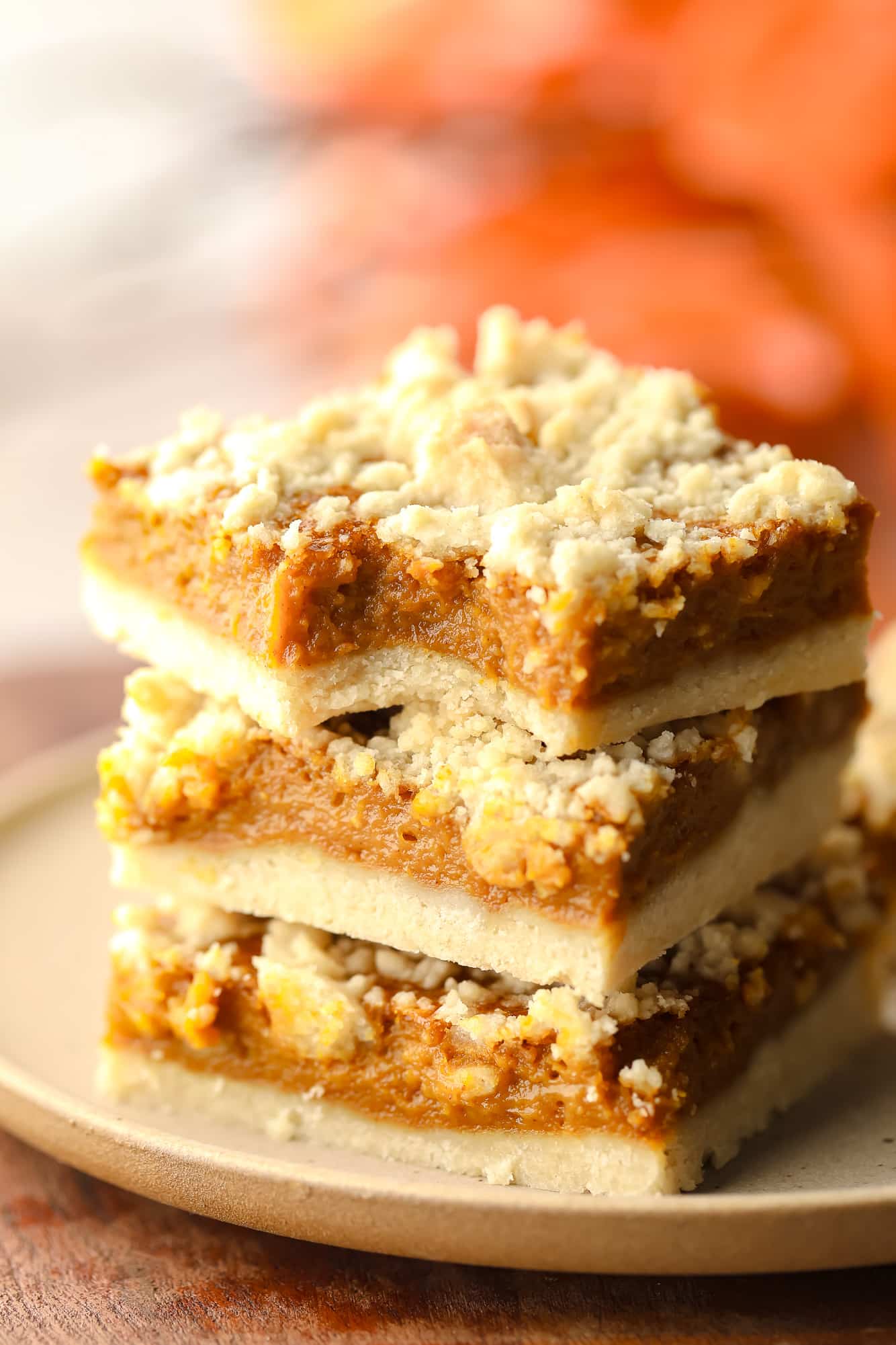 3 vegan pumpkin bars are stacked over each other.